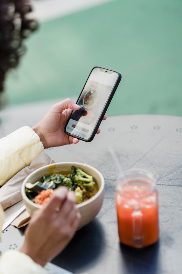 A person reviews the photos she took of her food.